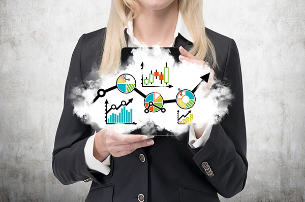Female professional holding a cloud with graph and chart icons