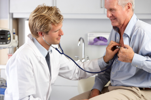 Elderly man getting a checkup with medical professional