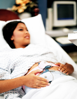 Pregnant woman in hospital bed