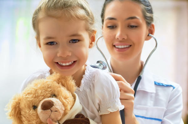 Pediatrician and child smiling during a checkup