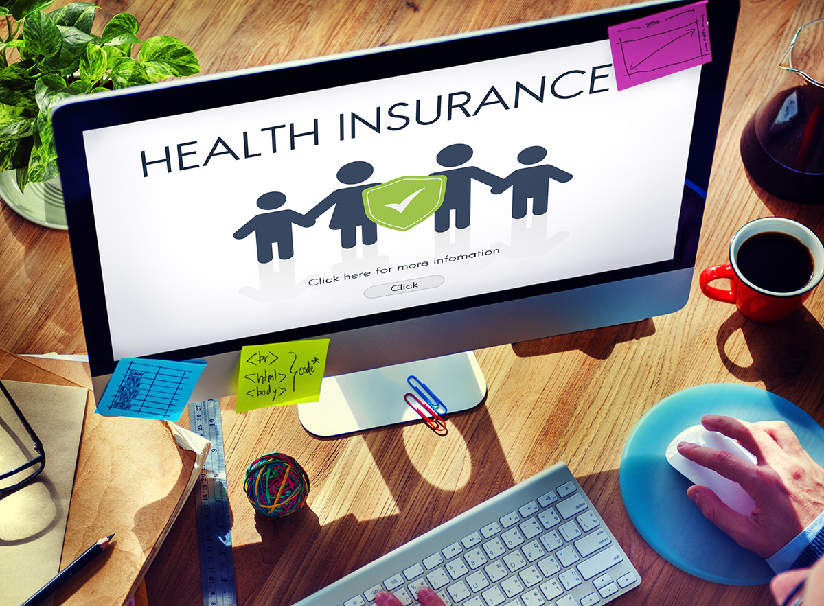 Desktop computer screen showing an icon of a family and the words "Health Insurance"
