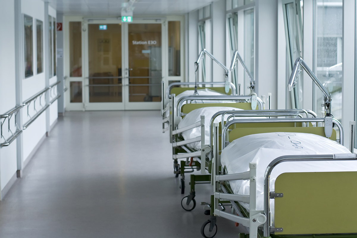 Hospital hallway lined with beds