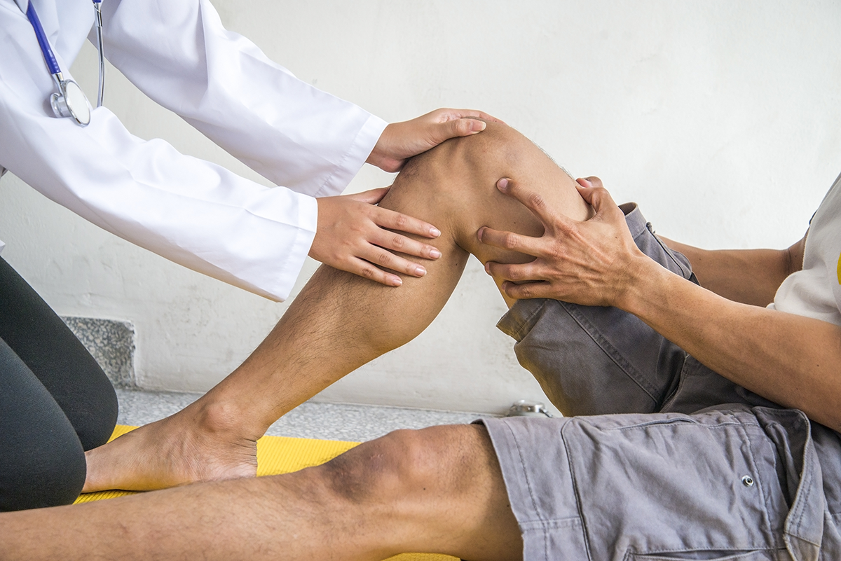 doctor examining a patient's knee