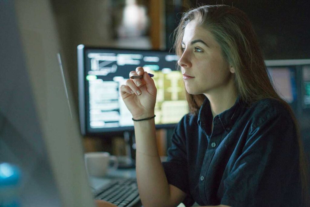 data integration strategy woman working on multiple desktops 